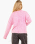 A woman shown from the back wearing a pink textured knit cardigan and dark gray jeans against a plain white background.