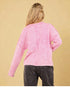 Pull rose délavé à coutures apparentes