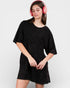 Woman wearing a black dress and pink headphones on a white background