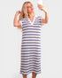 Woman taking a selfie wearing a blue and white striped dress on a plain background