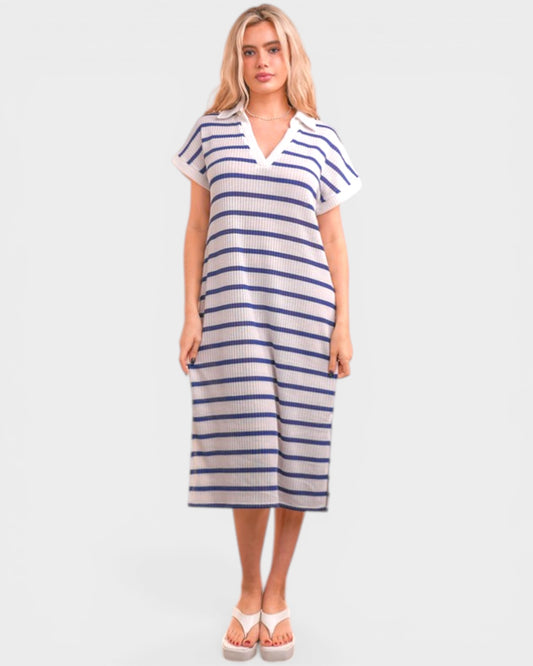 Woman wearing a blue and white striped dress on a plain background
