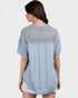 Woman wearing a light blue checkered shirt on a white background