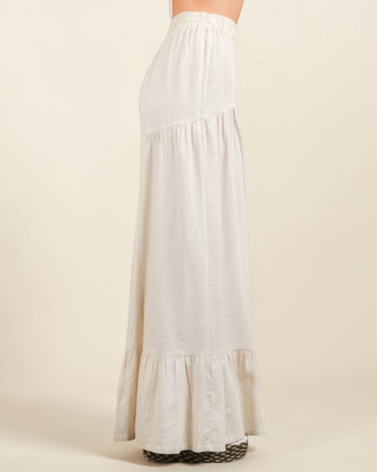 White long skirt with ruffled bottom on a beige background