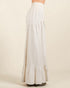 White long skirt with ruffled bottom on a beige background
