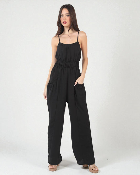 Woman wearing a black jumpsuit on a white background