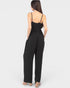 Black jumpsuit worn by a model on a white background