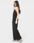 Woman wearing a black jumpsuit on a white background