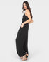 Woman wearing a black jumpsuit on a white background
