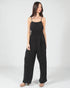 Woman wearing a black jumpsuit on a white background