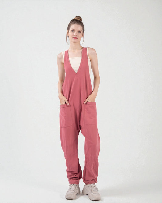 Woman wearing a pink jumpsuit on a white background