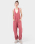 Woman wearing a pink jumpsuit on a white background