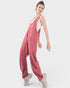 Woman wearing a pink jumpsuit on a white background