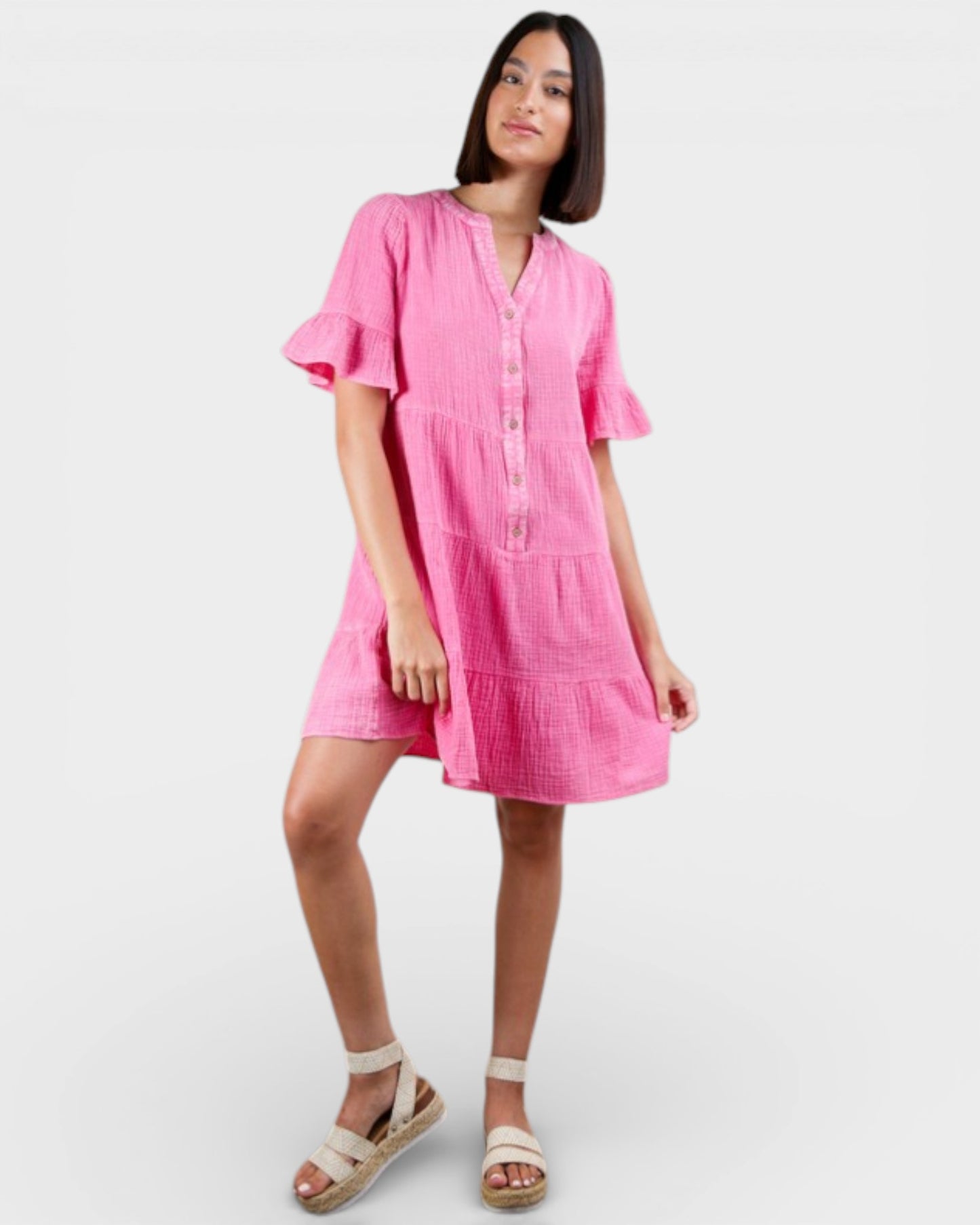 Woman wearing a pink dress on a white background