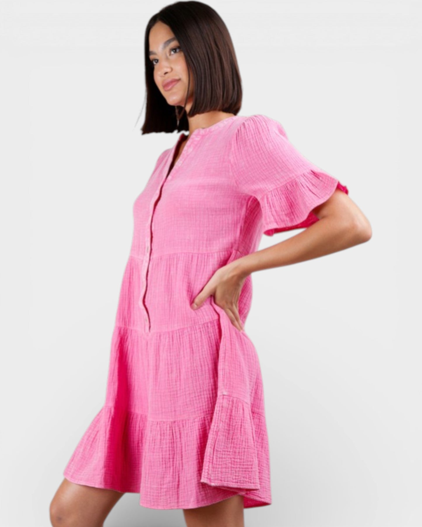 Woman wearing a pink dress against a white background