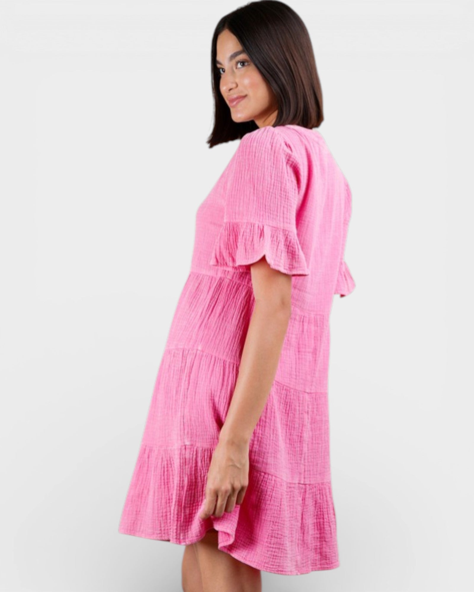 Woman wearing a pink dress against a white background