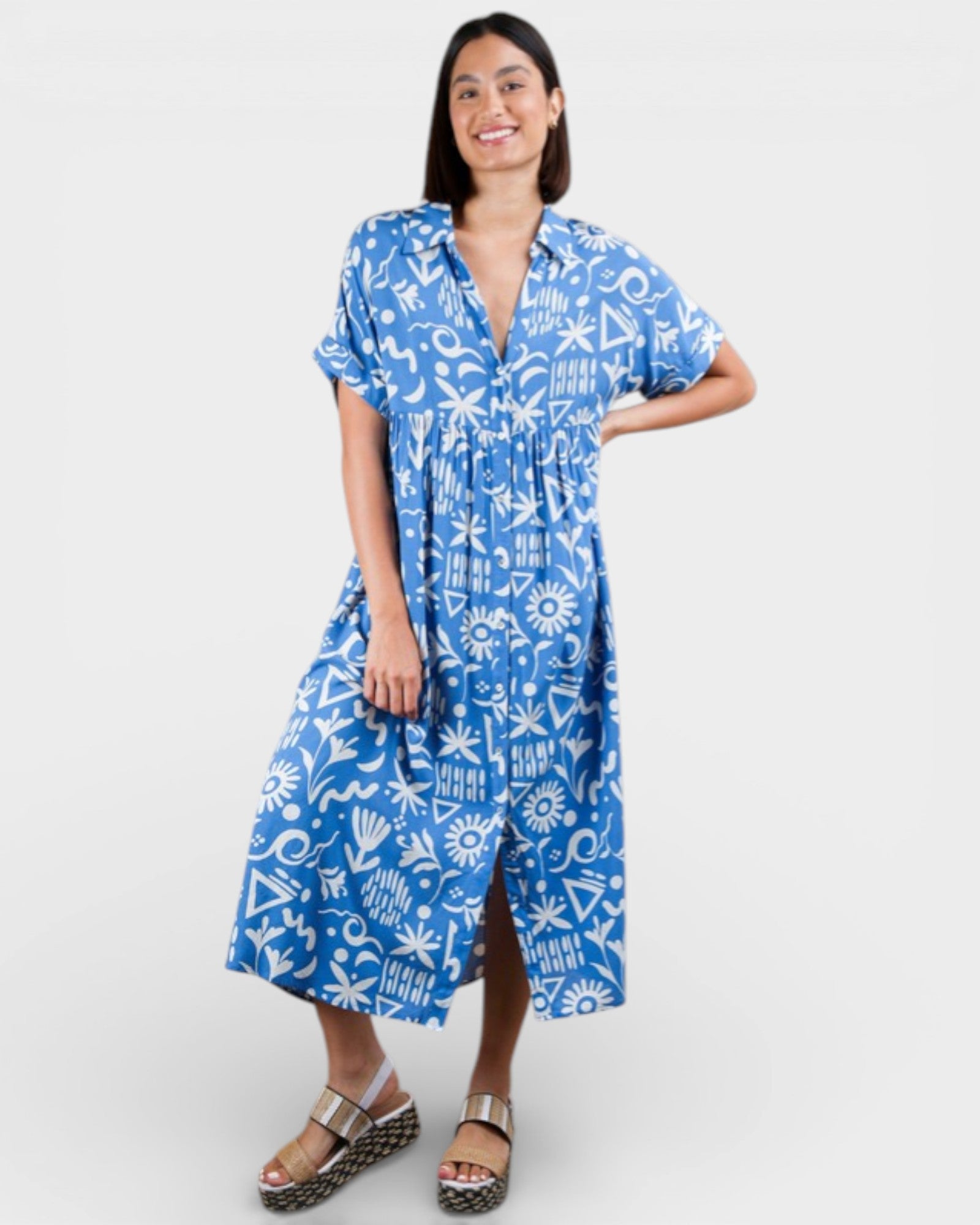 Woman wearing a blue patterned dress on a white background
