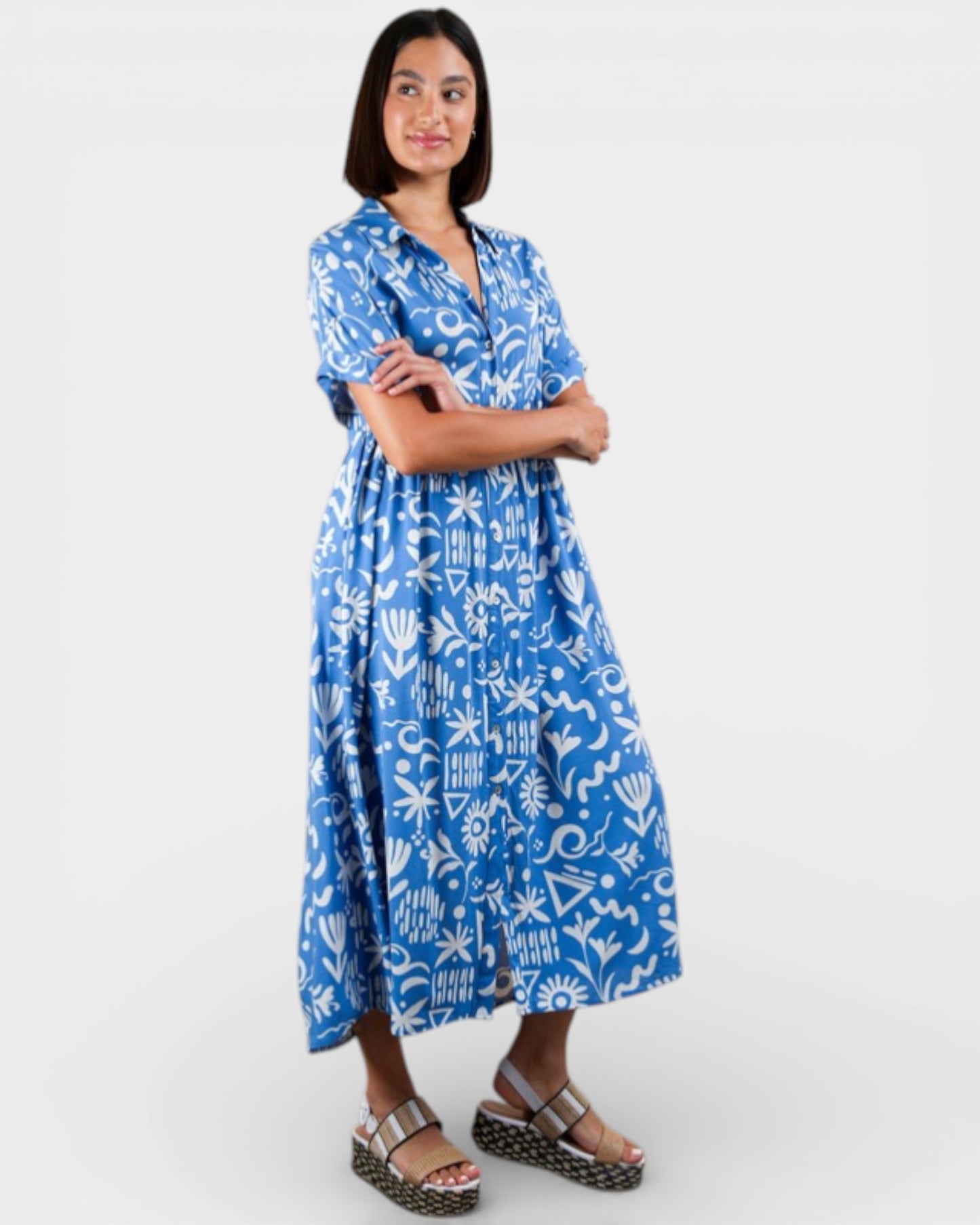 Woman wearing a blue patterned dress on a white background