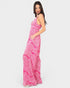 Woman wearing a pink patterned dress on a white background