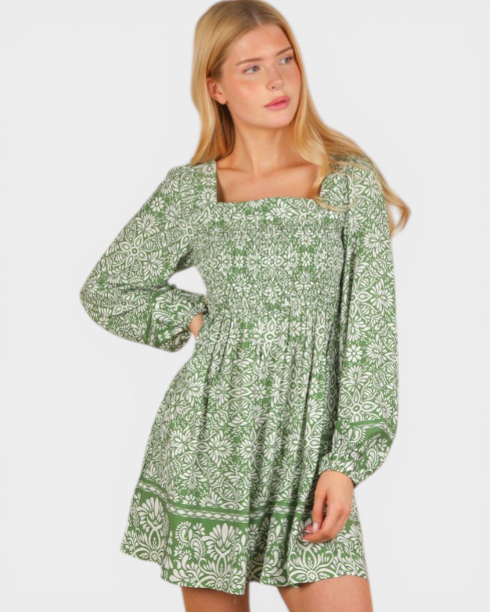 Woman wearing a green floral dress on a white background