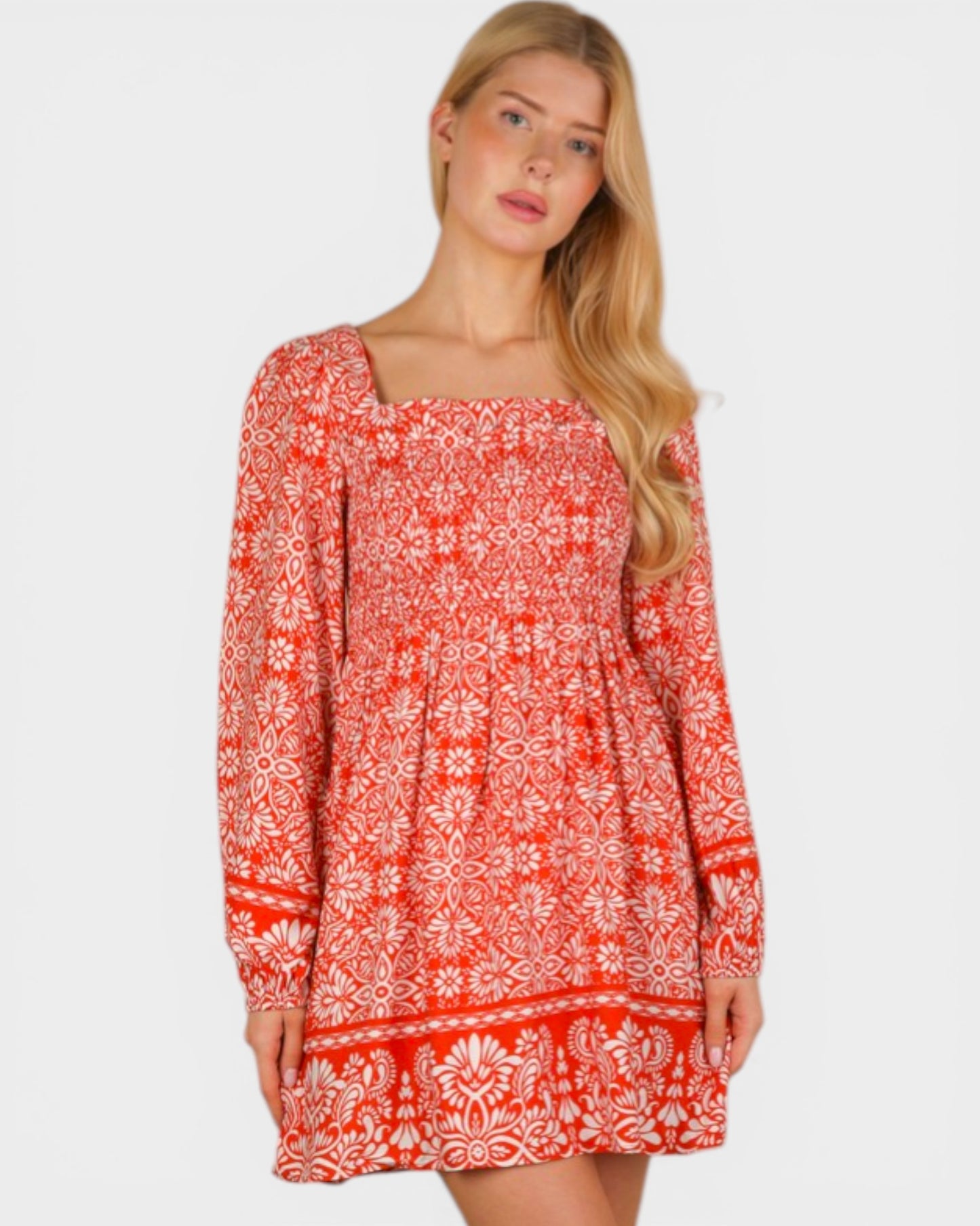 Woman wearing a red patterned dress on a white background