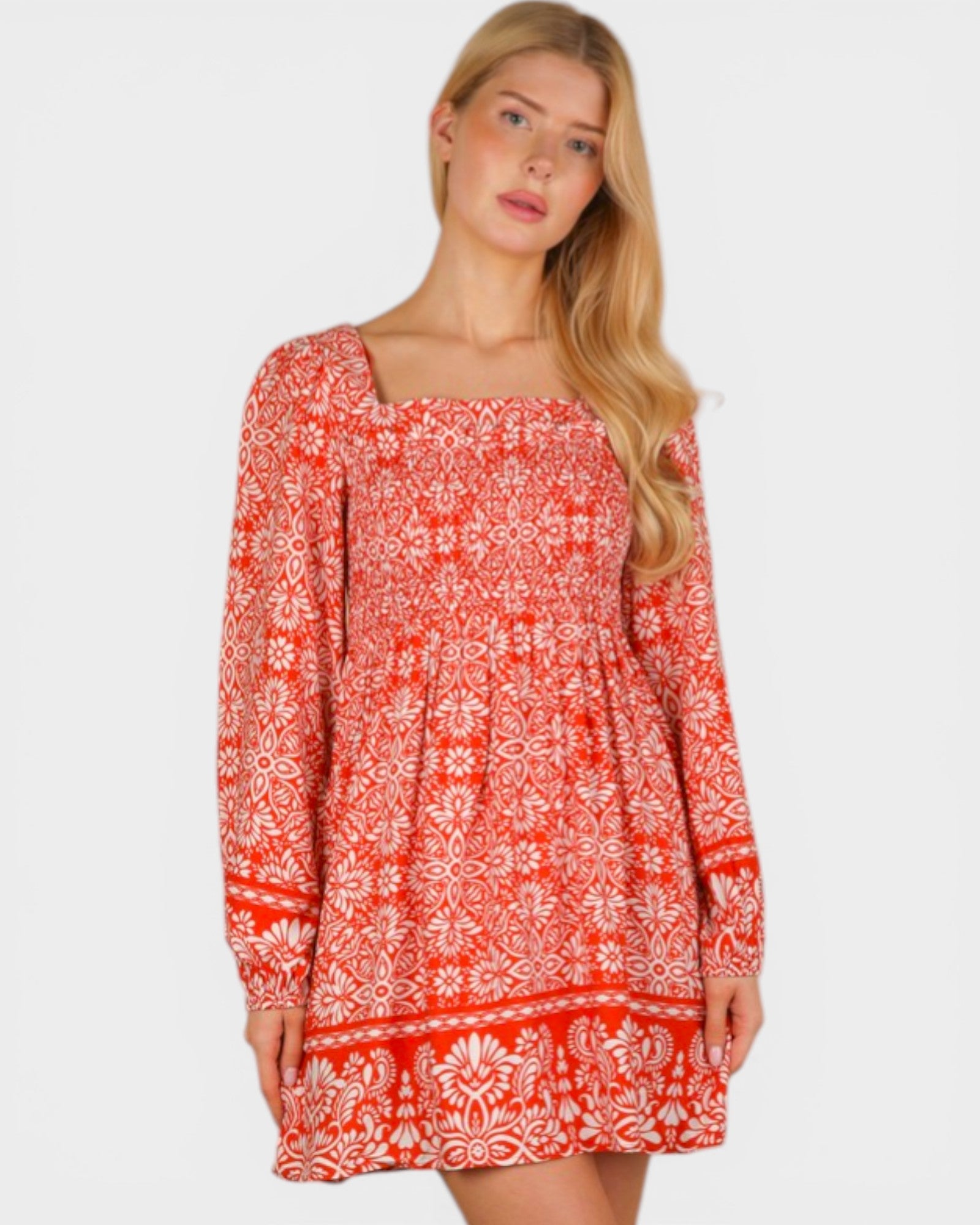 Woman wearing a red patterned dress on a white background