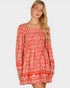 Woman wearing a red patterned dress on a white background