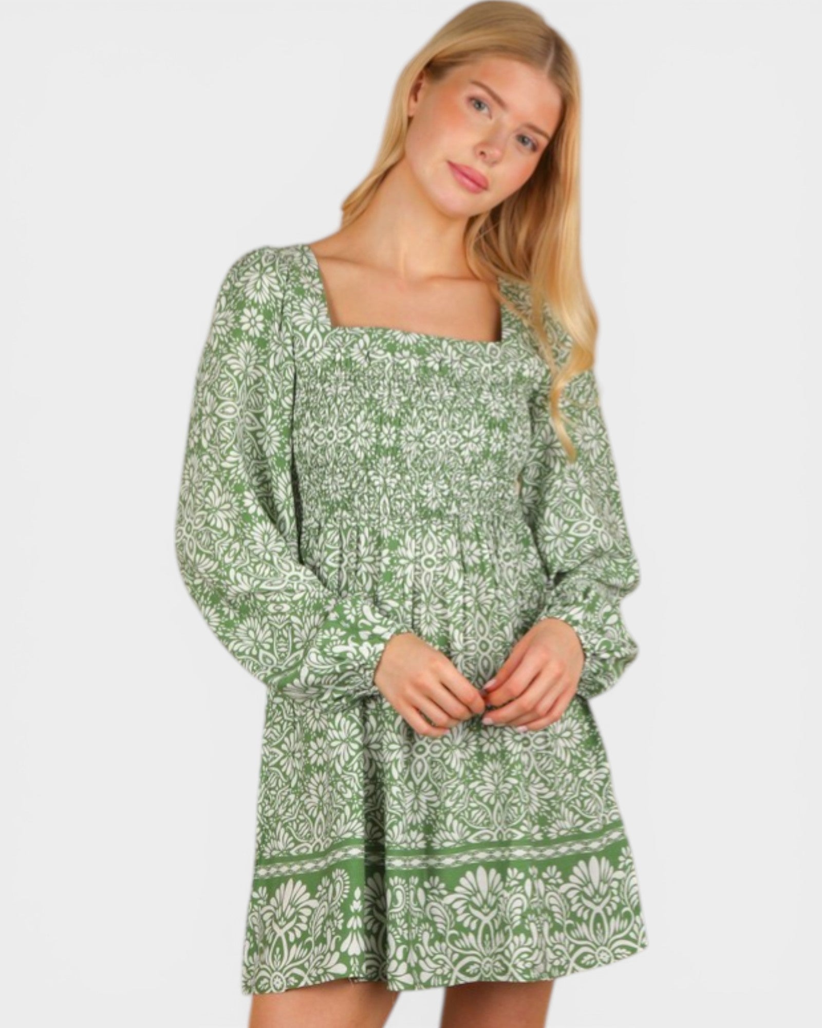 Woman wearing a green floral dress on a white background