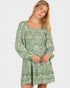 Woman wearing a green floral dress on a white background