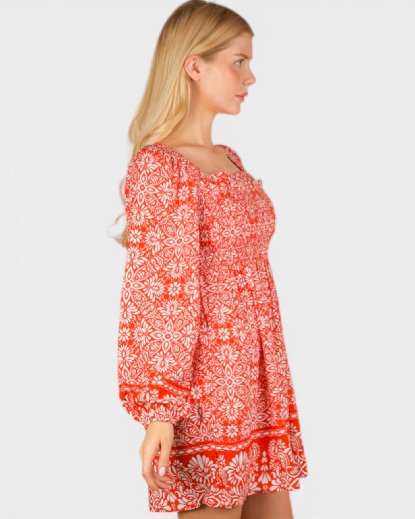 Woman wearing a red floral dress on a white background