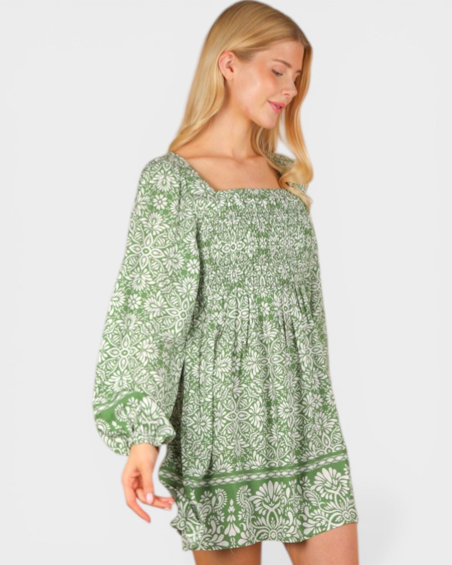 Woman wearing a green floral dress on a white background