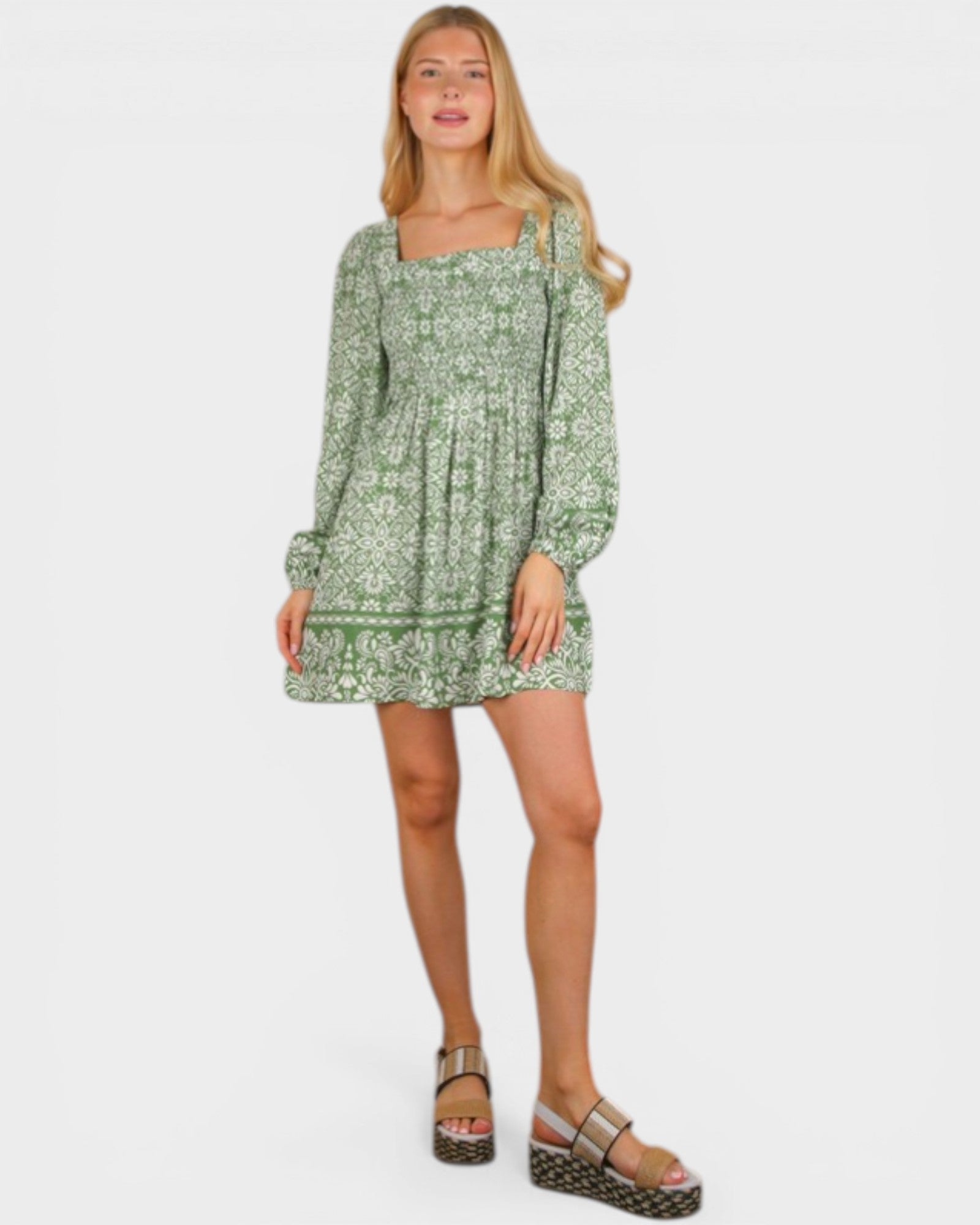 Woman wearing a green floral dress on a white background
