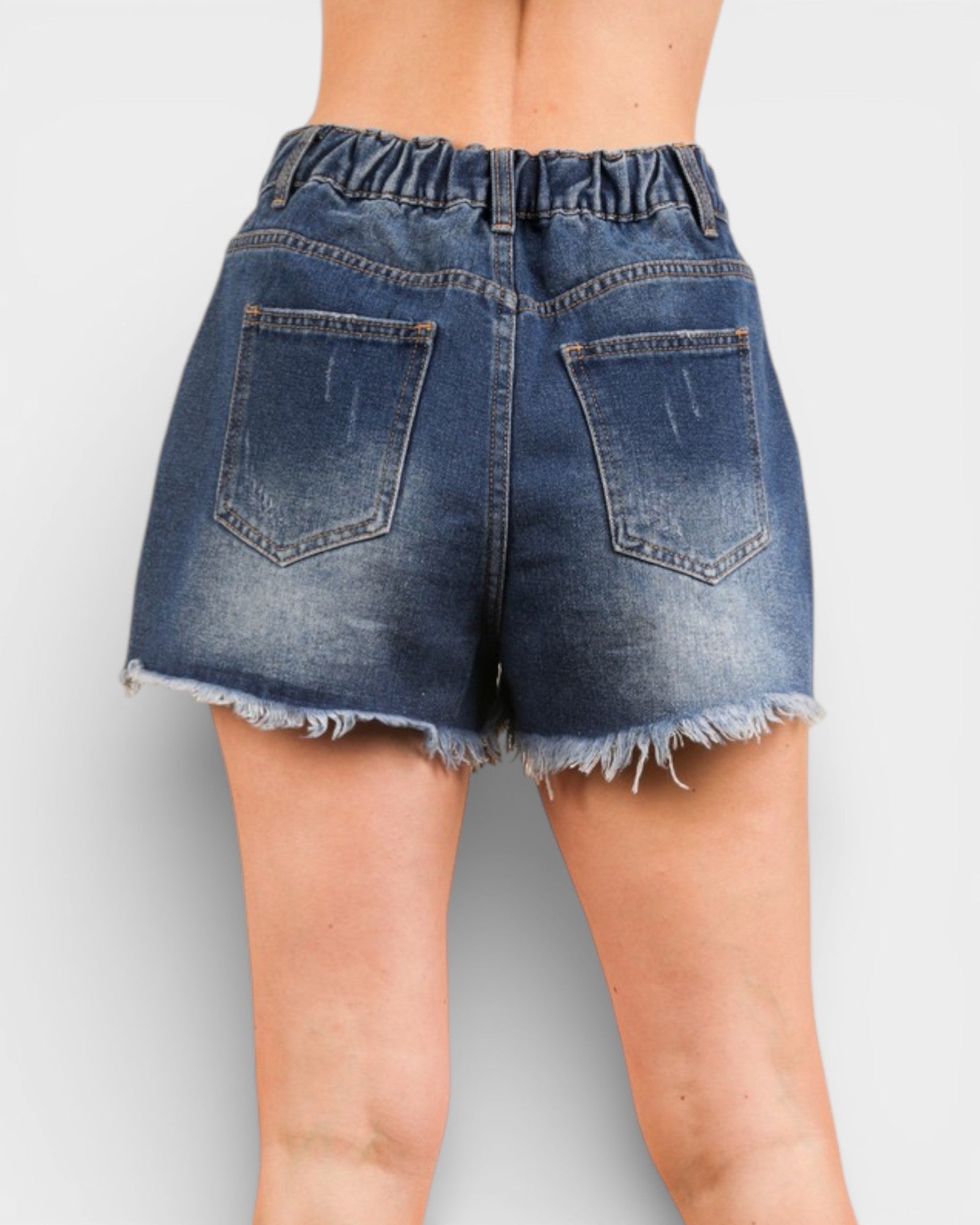 Blue denim shorts on a plain background