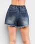 Blue denim shorts on a plain background