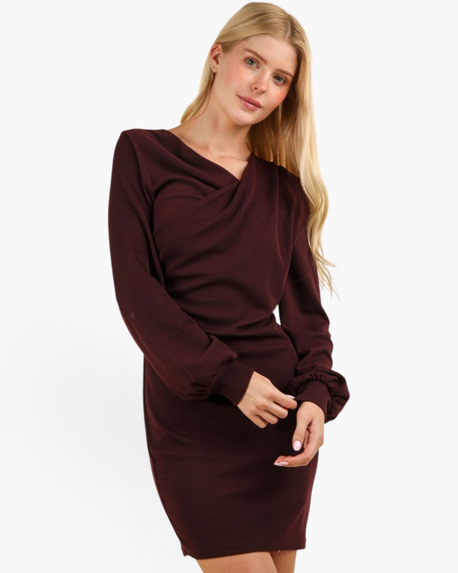 A woman modeling a long-sleeve bodycon mini dress in deep burgundy with a draped cowl neckline, photographed against a clean white studio background.