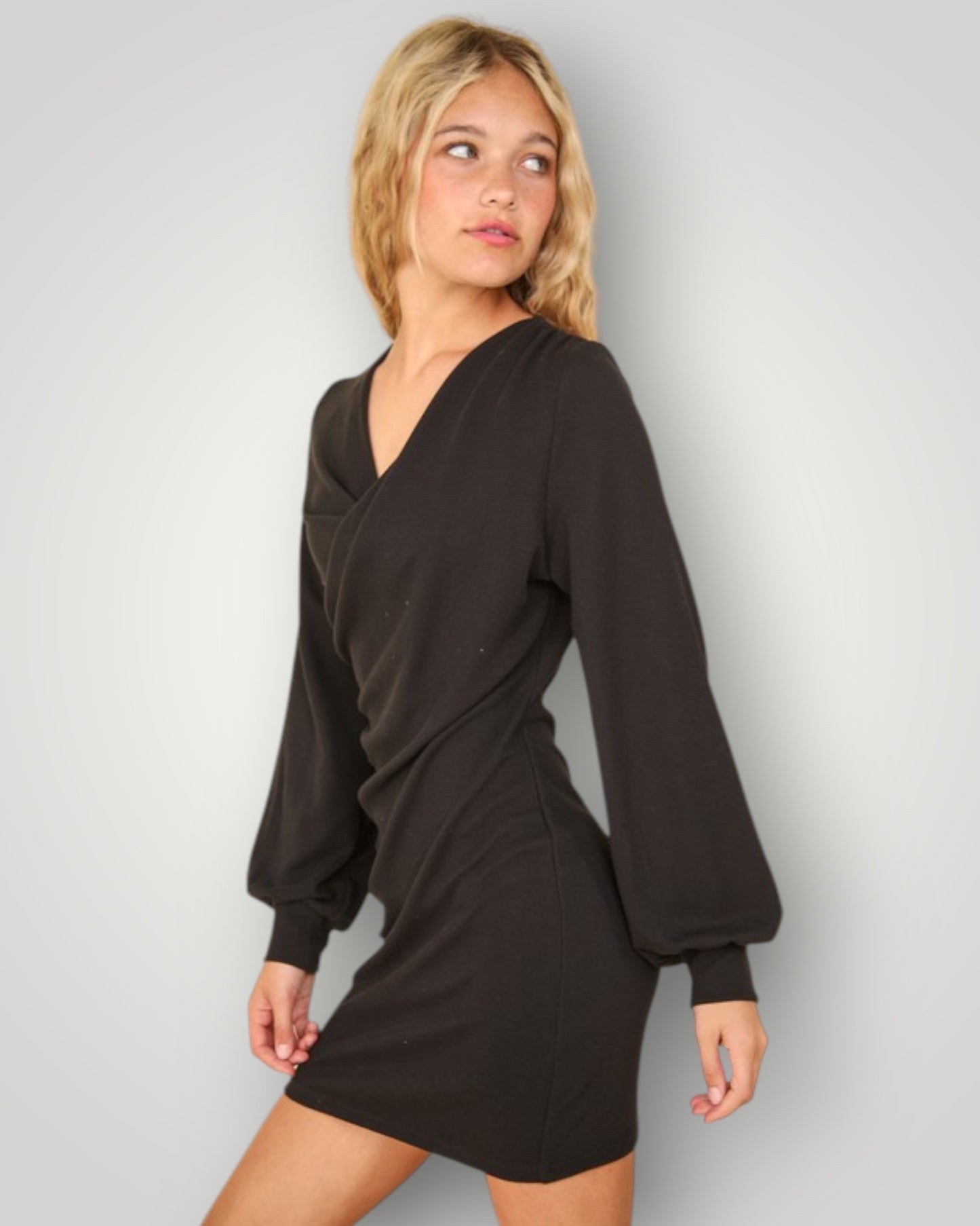 Woman wearing a black dress against a plain background