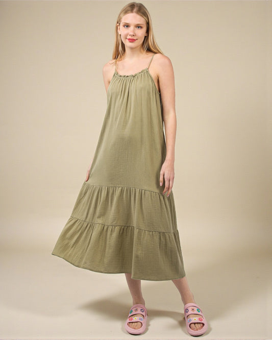 Woman wearing a green dress against a beige background