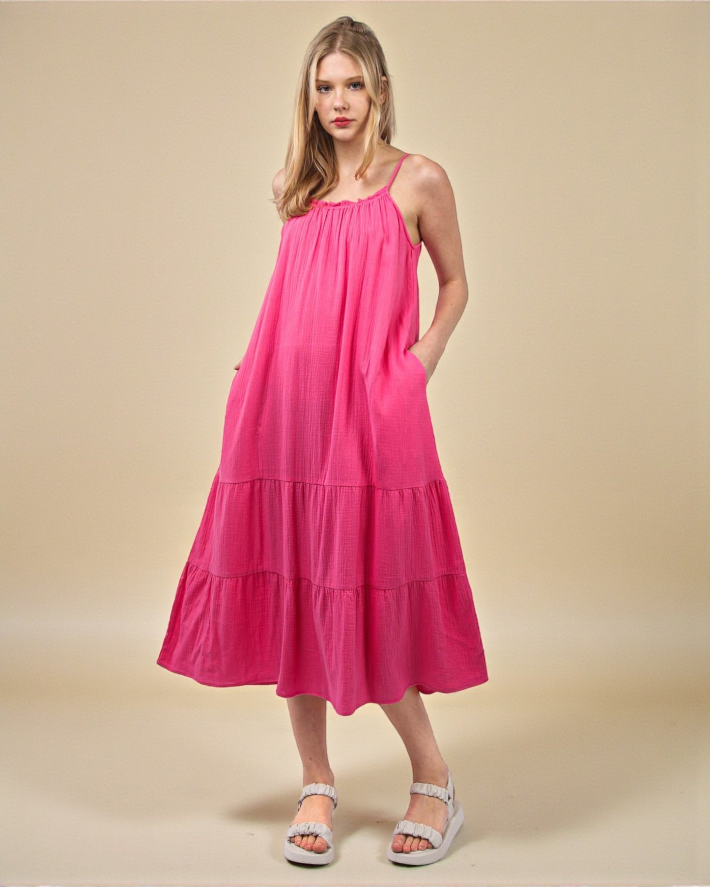 Woman wearing a pink dress on a beige background