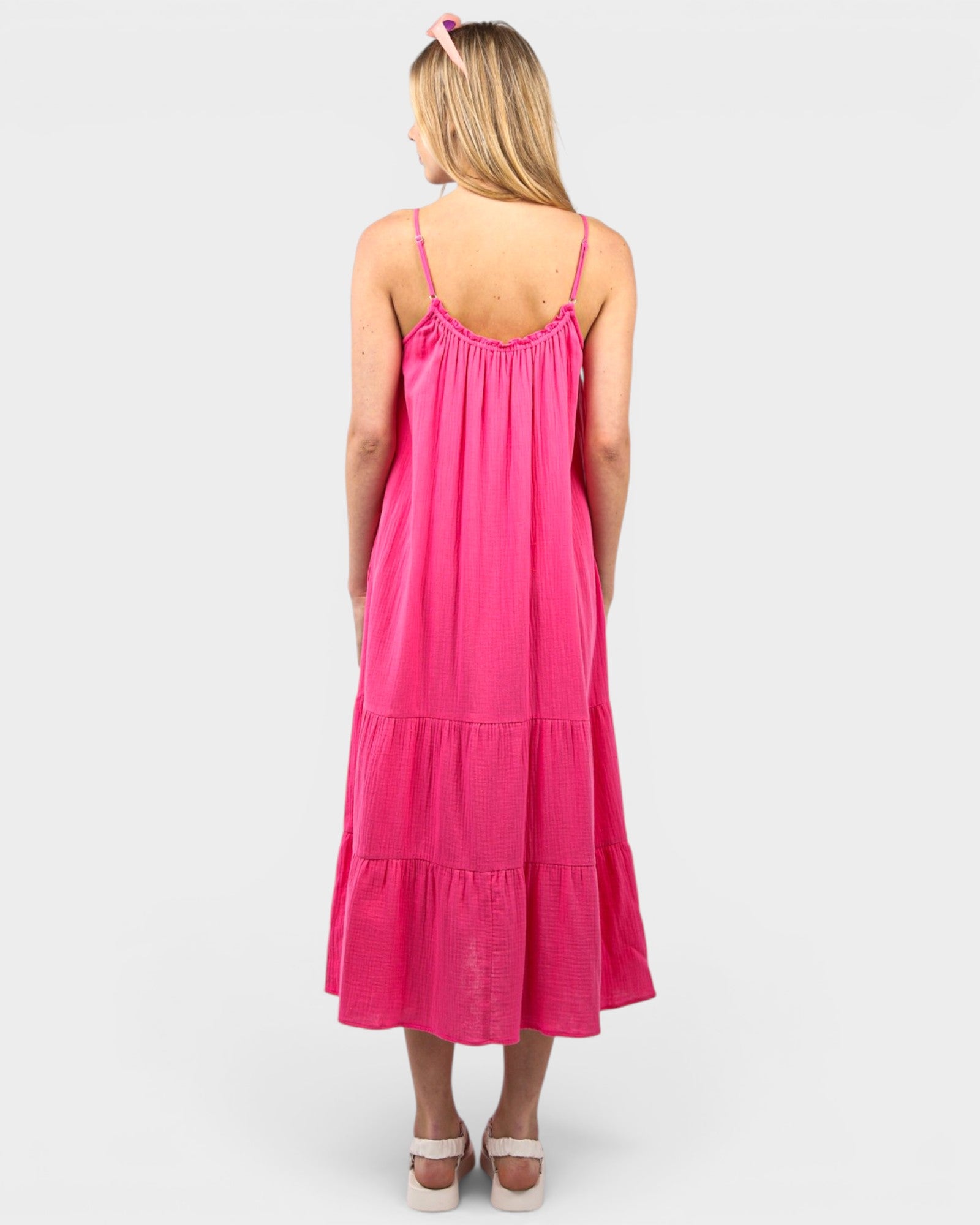 Woman wearing a pink dress on a white background