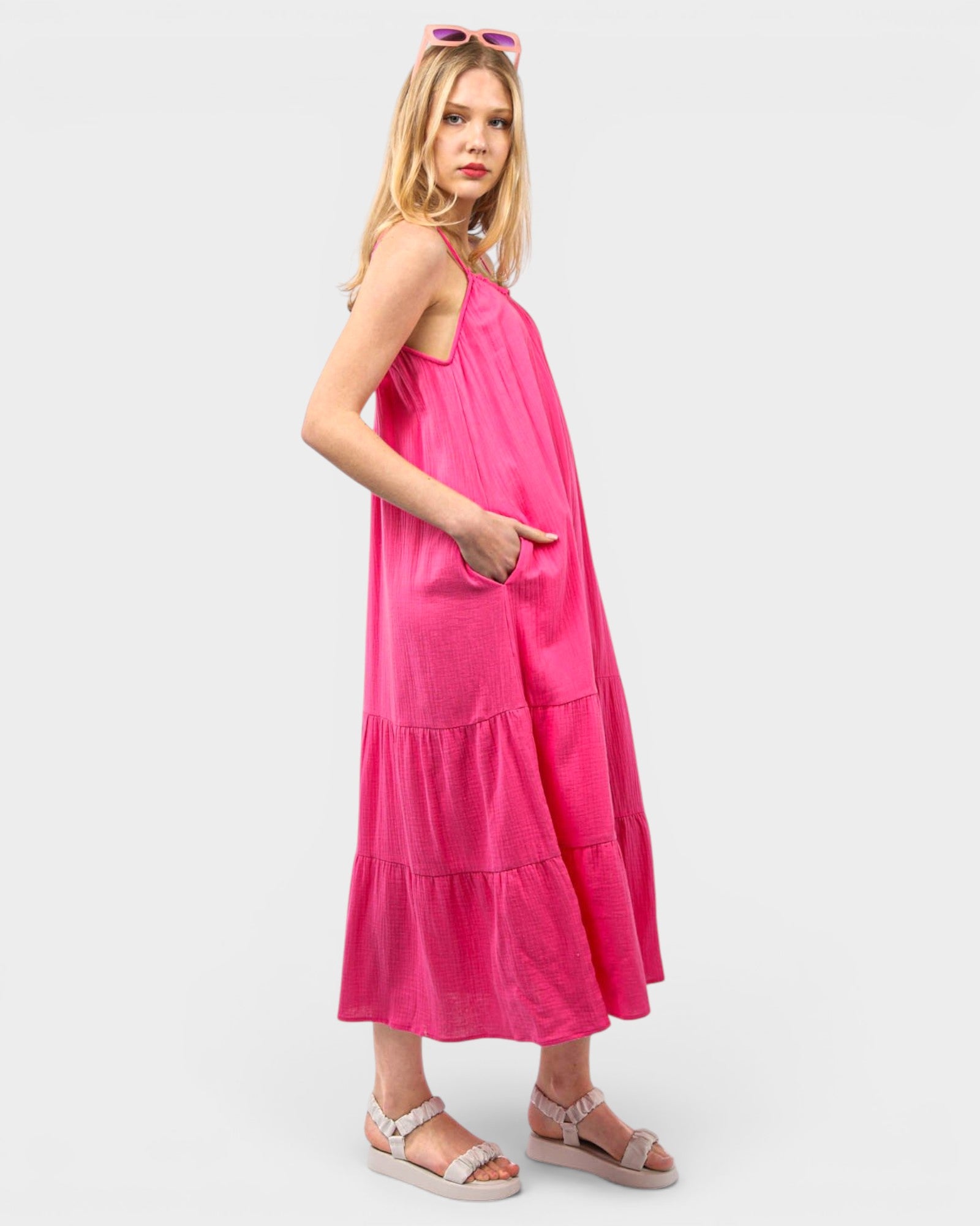 Woman wearing a bright pink dress on a white background