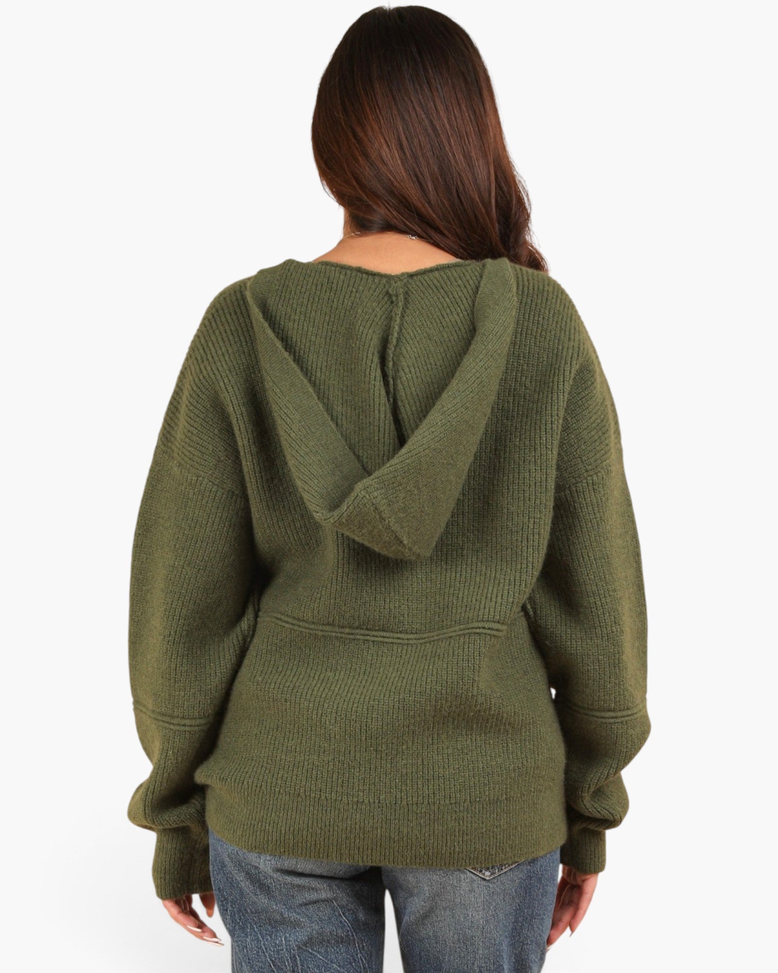A woman viewed from the back wearing an olive green ribbed knit hoodie with a split hood design, paired with blue jeans, against a plain white background.