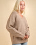 Woman wearing a beige sweater against a beige background