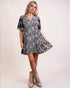 Woman wearing a floral dress with beige boots on a white background