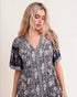 Woman wearing a floral dress against a plain background