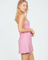Woman wearing a pink dress against a white background