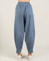 Blue baggy pants worn by a person on a white background
