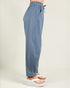 Blue pants worn by a person on a plain background