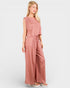 Woman wearing a pink jumpsuit on a white background