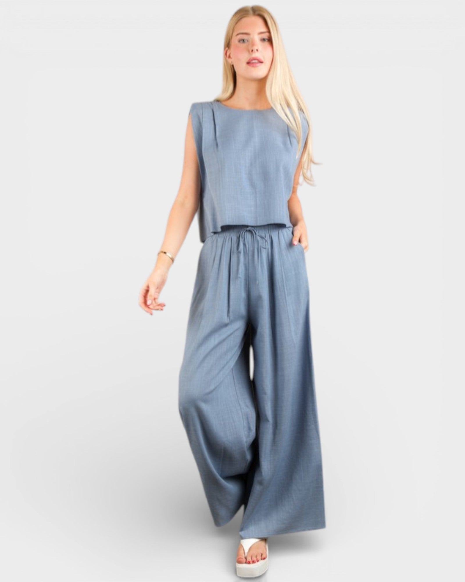 Woman wearing a blue jumpsuit on a white background