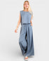 Woman wearing a blue jumpsuit on a white background
