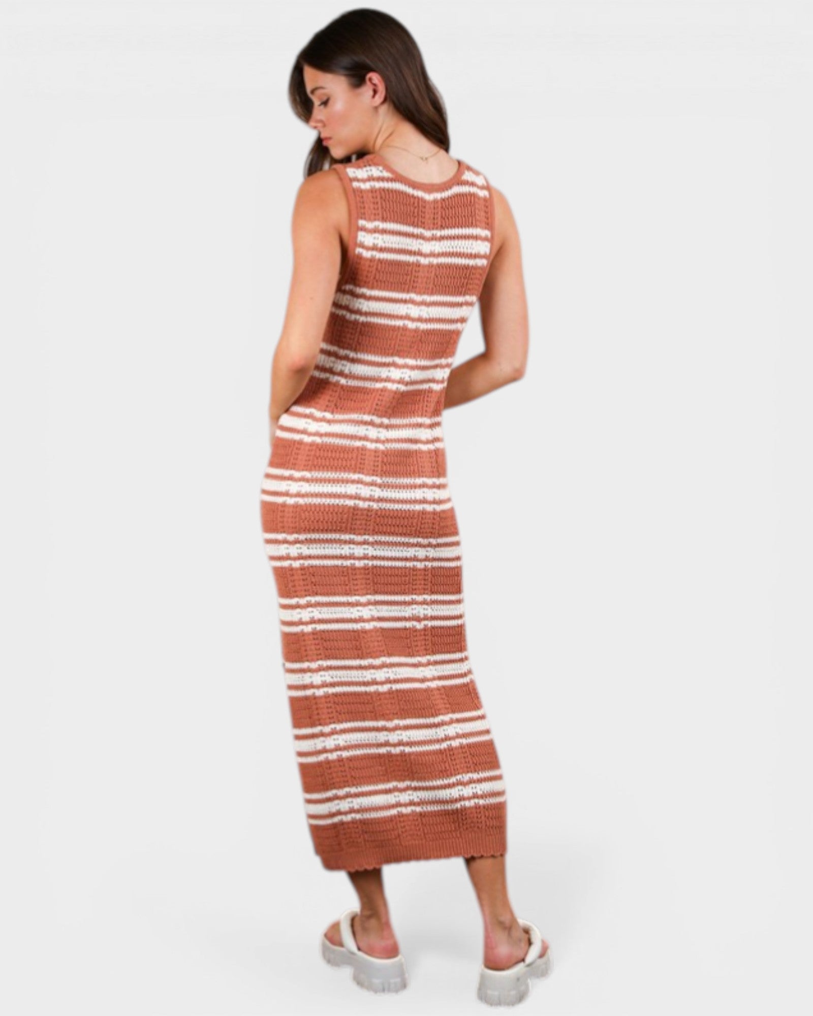 Woman wearing a striped dress on a white background